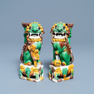 A pair of Chinese sancai-glazed biscuit Buddhist lion joss stick holders, Kangxi