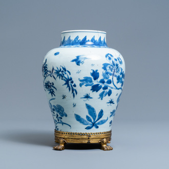 A Chinese blue and white vase on a gilt bronze foot, Kangxi