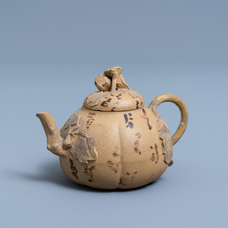 A bichrome Chinese Yixing stoneware teapot and cover with applied floral design, 19th C.