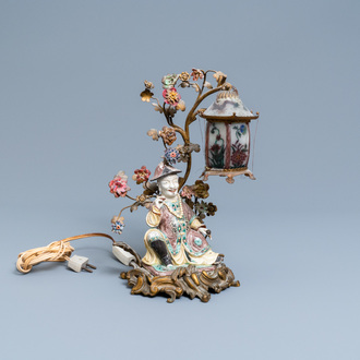 A Chinese famille verte figure mounted into a lamp with gilt bronze, glass and Samson porcelain, 19th C.
