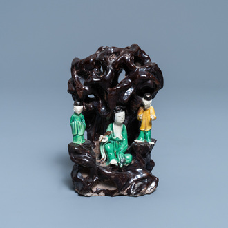 A Chinese verte biscuit group with figures near a cave, Kangxi