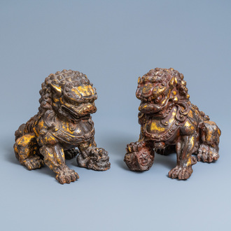 A pair of large Chinese gilt-lacquered iron models of Buddhist lions, 18/19th C.