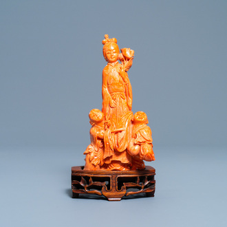 A Chinese carved red coral group of a lady with two boys, 19/20th C.