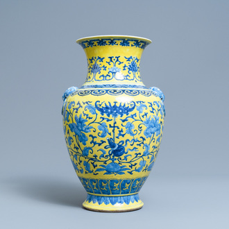 A Chinese blue and white yellow-ground vase with floral design, 19th C.