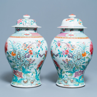 A pair of Chinese famille rose vases and covers, Qianlong mark, 19th C.
