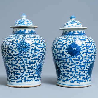 A pair of Chinese blue and white 'lotus scroll' vases and covers, Kangxi