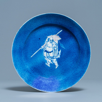 A Chinese blue, white and copper red powder blue-ground dish, Kangxi