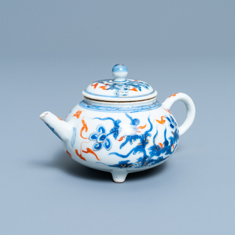 A Chinese blue, white, iron red and gilt tripod teapot and cover, Kangxi
