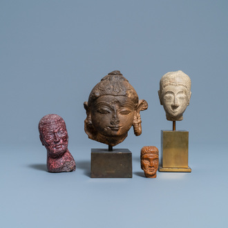 Four various carved stone heads, 17th C. and later