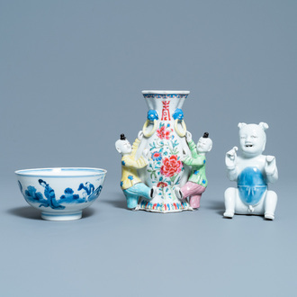 A Chinese blue and white bowl, a figure of a boy and a famille rose wall vase, Kangxi/Qianlong