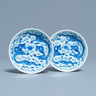 A pair of Chinese blue and white 'dragon' saucers, Kangxi mark, 19th C.