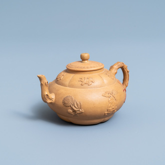 A bichrome Chinese Yixing stoneware teapot and cover with applied design, Kangxi