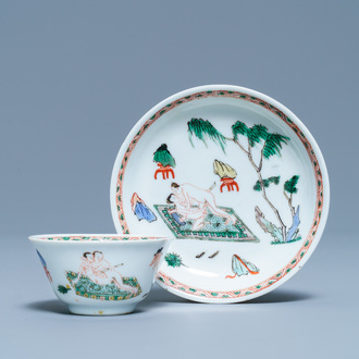 A Chinese famille verte 'erotical subject' cup and saucer, Kangxi