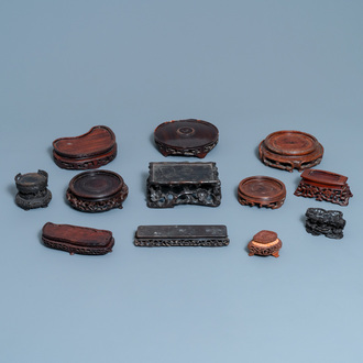 Twelve Chinese reticulated carved wooden stands, 19/20th C.