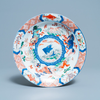 A Chinese famille verte dish with a carp surrounded by horses and Buddhist lions, Kangxi