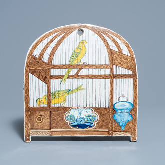 A rare polychrome Dutch Delft trompe l'oeil plaque with two canaries in a birdcage, 18th C.