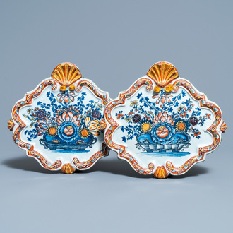 A pair of polychrome Dutch Delft 'flower basket' plaques, 18th C.