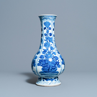 A Chinese blue and white bottle vase with flower arrangements, Kangxi