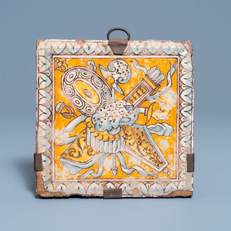 A maiolica floor tile with weapons and armoury, Italy or France, 16/17th C.