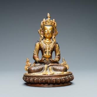 A Nepalese coral- and turquoise-inlaid partly gilded copper alloy figure of Buddha, 19/20th C.