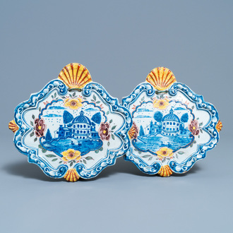 A pair of polychrome Dutch Delft plaques with a castle by a lake, 18th C.