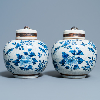 A pair of Chinese blue and white Nanking crackle-glazed jars and covers, 19th C.