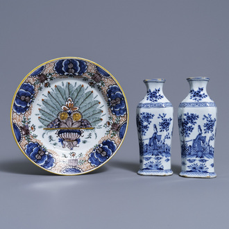 A pair of Dutch Delft blue and white vases and a 'peacock's tail' plate, 18th C.