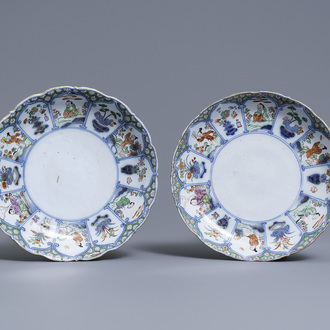 A pair of polychrome petit feu and gilded Dutch Delft famille verte-style chinoiserie plates, 1st quarter 18th C.