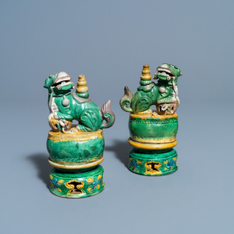 A pair of Chinese sancai-glazed biscuit Buddhist lion joss stick holders, Ming