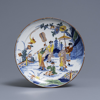 A polychrome Dutch Delft chinoiserie plate with figures in a garden, 18th C.