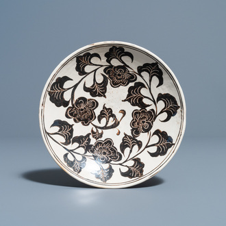 A Chinese Cizhou plate with carved floral design, Song/Ming