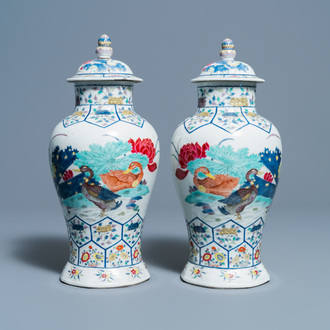 A pair of Chinese famille rose 'mandarin ducks' vases and covers, Kangxi mark, Republic