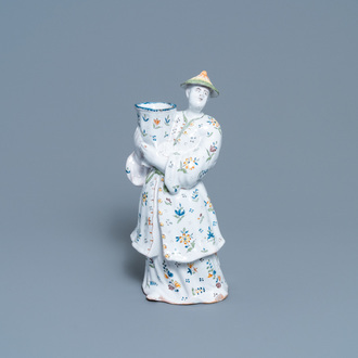 A polychrome French faience candle holder in the shape of a Chinaman, Lille, 18th C.