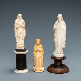 Two figures of Madonna and one of Christ in ivory and bone, 19th C.