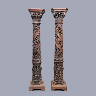 A pair of reticulated carved oak Corinthian columns with cherub heads and vines, 17th C.