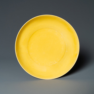 A Chinese monochrome yellow-glazed plate, Kangxi mark and of the period