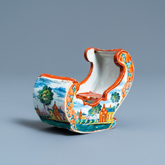 A polychrome Dutch Delft petit feu pipe stand modelled as a sleigh, 18th C.