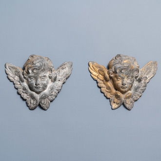 A pair of parcel-gilt lead winged cherub heads, 17th C.