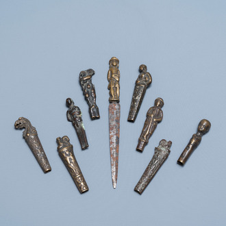 Nine bronze and brass knife handles including one with a knife, 16/18th C.