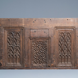 A carved oak front panel of a coffer with tracery panels, 15th C.