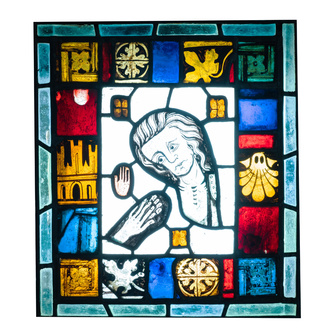 A composite stained and painted glass window mounted in lead alloy, France, 13th C. and later