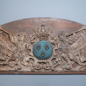 A large polychromed carved oak panel with putti and trophies flanking the royal coat of arms of France, 18th C.