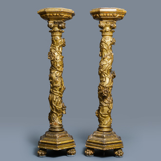 A pair of gilded wooden columns with Ionic capitals, floral swirls and lion paws, Italy, 18th C.