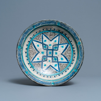 A polychrome Persian pottery dish with geometrical design, 14th C.