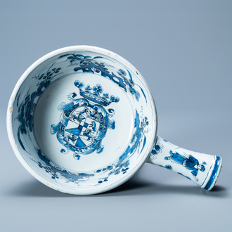 A rare Dutch Delft blue and white warming bowl with the arms of the Austrian von Zinzendorf family, late 17th C.