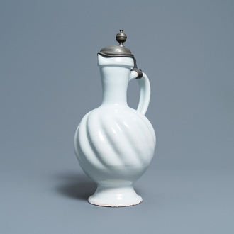 A large gadrooned white Dutch Delftware jug with pewter cover, 17th C.