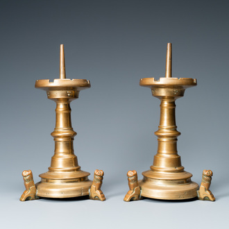 A pair of brass alloy candlesticks on lion feet, The Netherlands, 1st half 15th C.