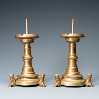 A pair of brass alloy candlesticks on lion feet, The Netherlands, 1st half 15th C.