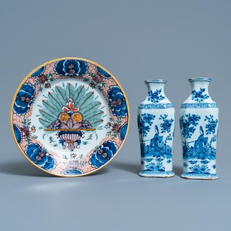 A pair of Dutch Delft blue and white vases and a 'peacock's tail' plate, 18th C.