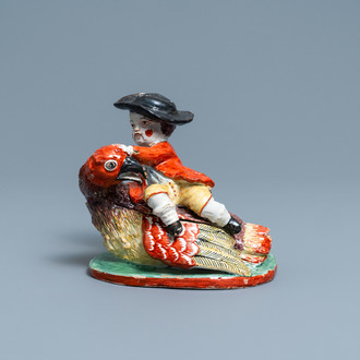 A polychrome Dutch Delft box and cover in the shape of a boy on a bird, 18th C.